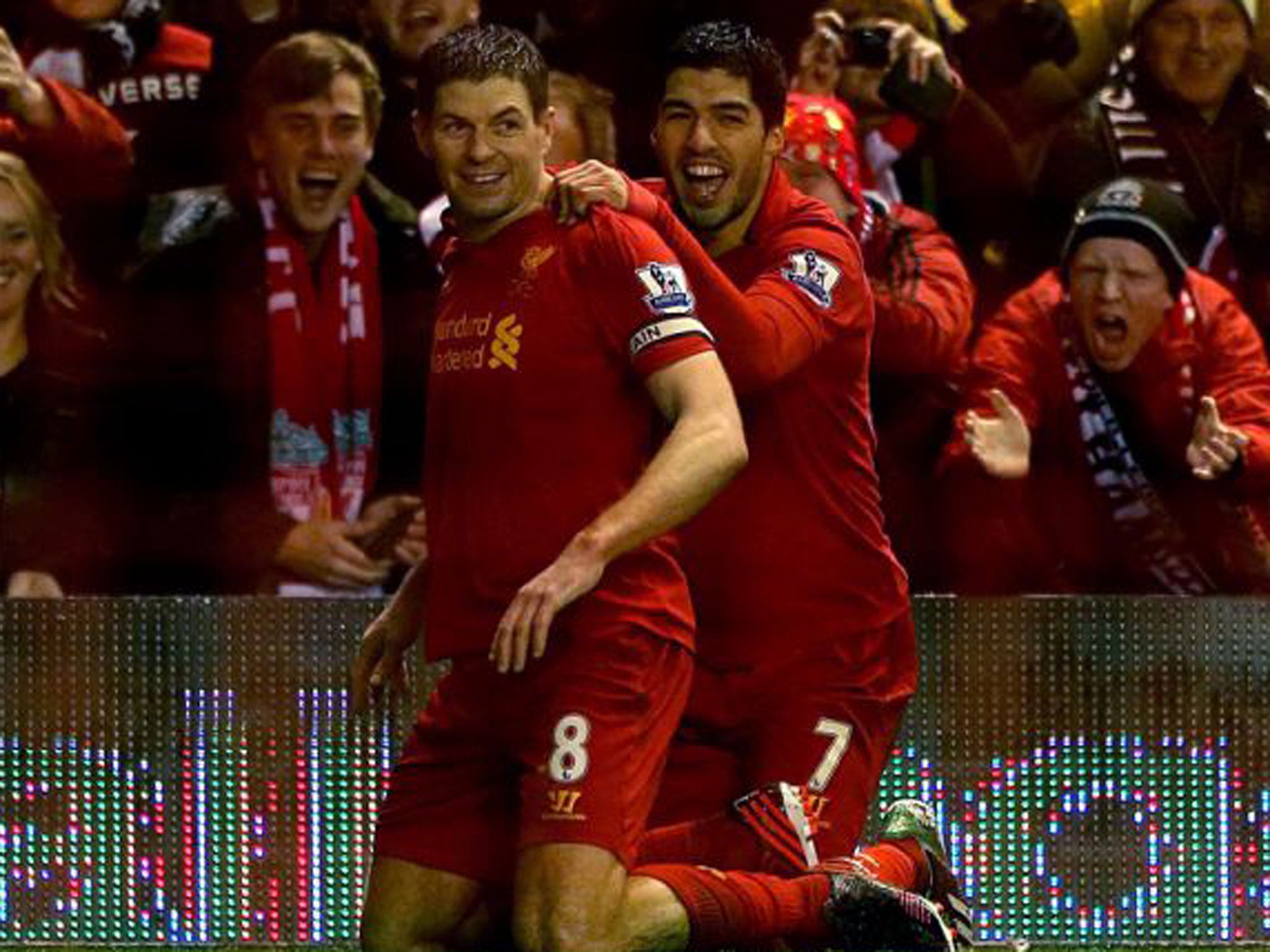 Steven Gerrard is congratulated by Luis Suarez after scoring against Fulham on Saturday