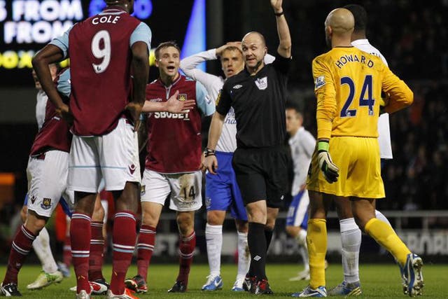 Carlton Cole is shown a red card by referee Anthony Taylor on Saturday