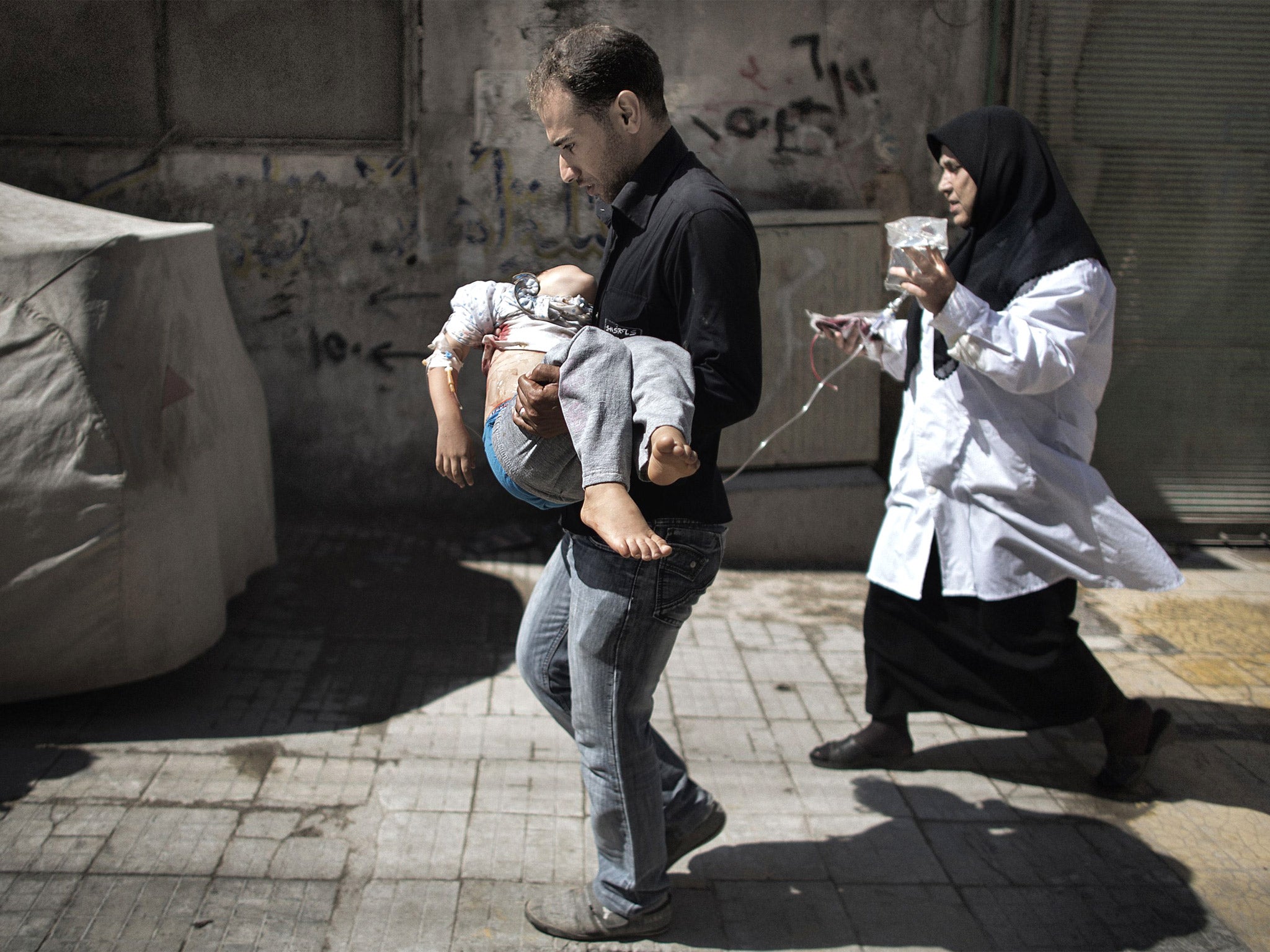 A young victim of the Syrian conflict is taken for treatment in Aleppo