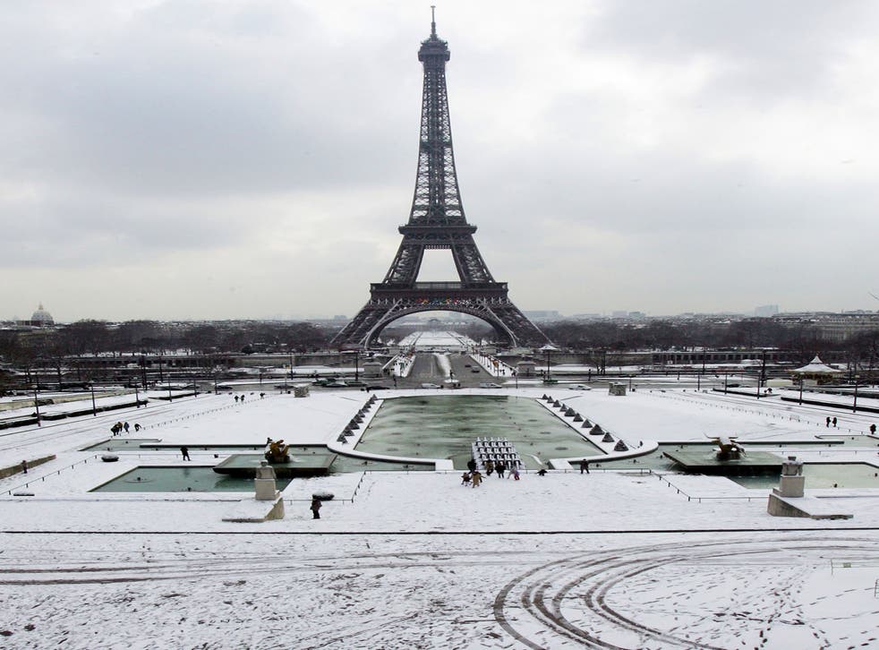 Snow covers the Trocadero gardens in front of the Eiffel Tower in Paris