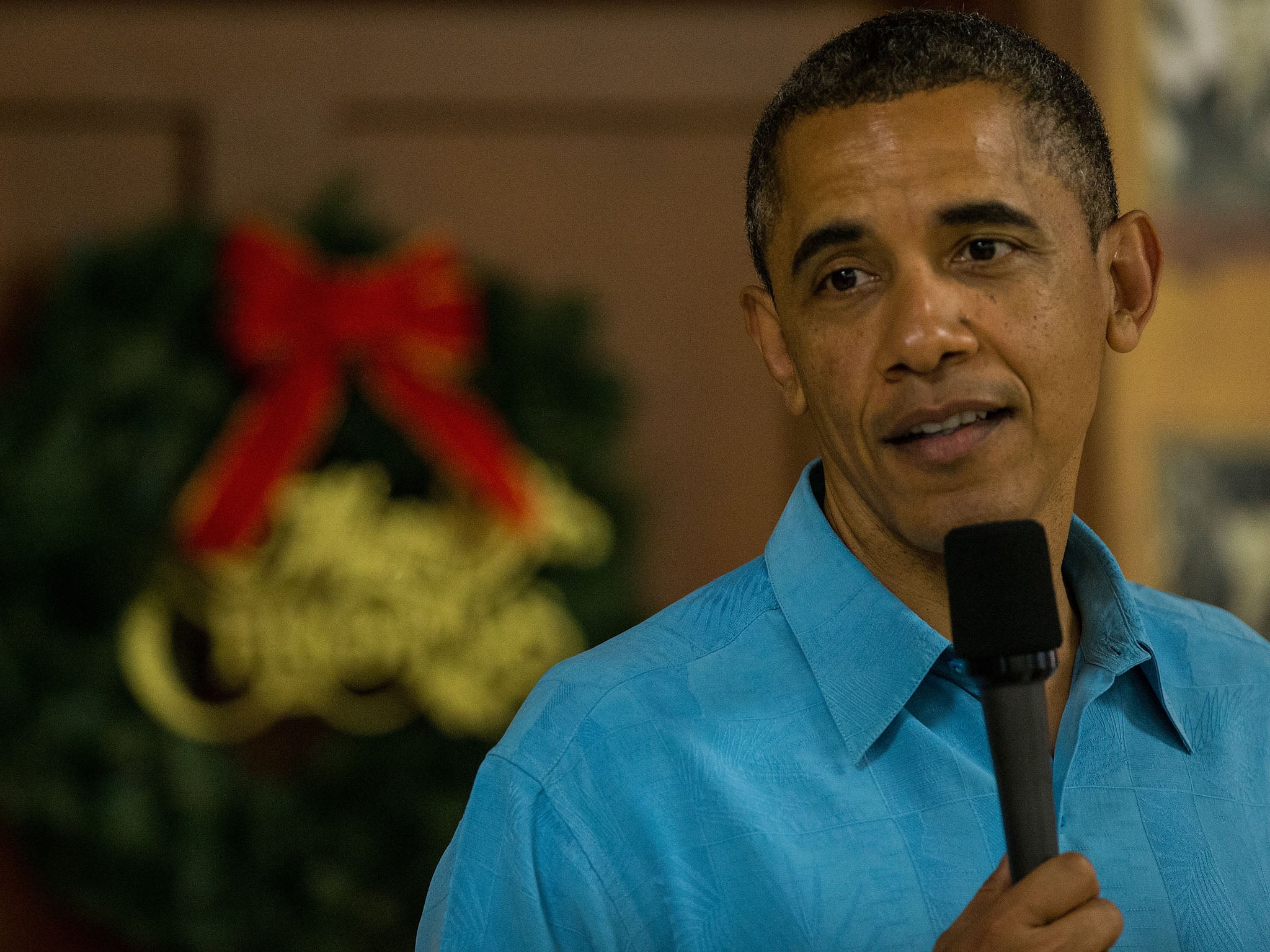 US President Barack Obama delivers remarks while visiting military personnel eating Christmas Dinner at Anderson Hall at Marine Corps Base Hawaii