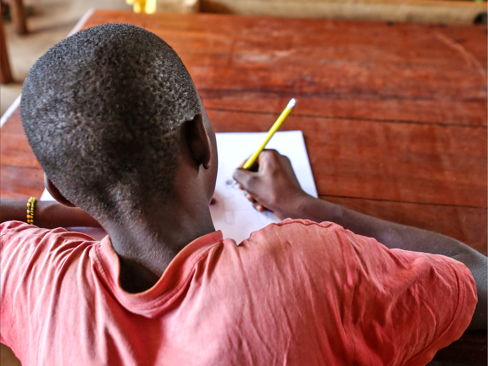 A boy during the Alphabetization class at the Unicef-supported transit centre