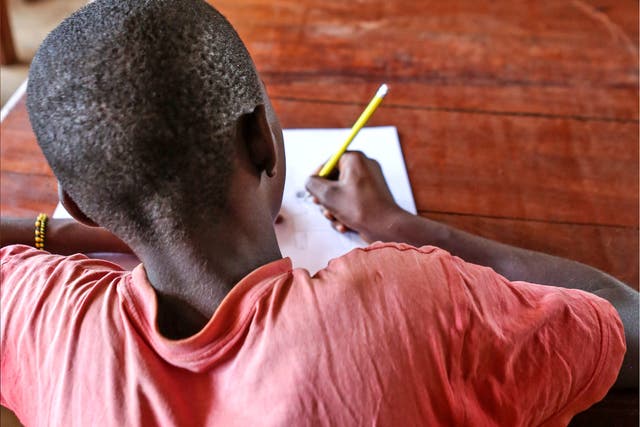A boy during the Alphabetization class at the Unicef-supported transit centre