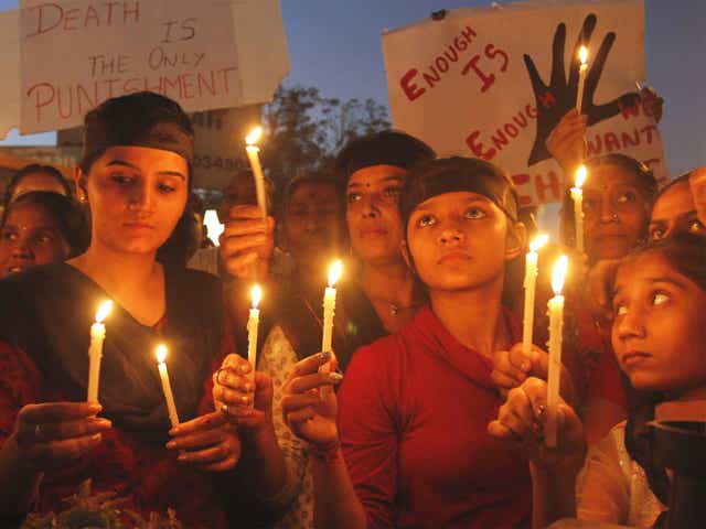 Indians holds candles to condemn the brutal gang-rape of a woman