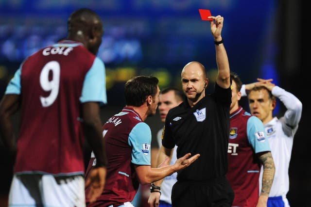 Carlton Cole is shown a red card