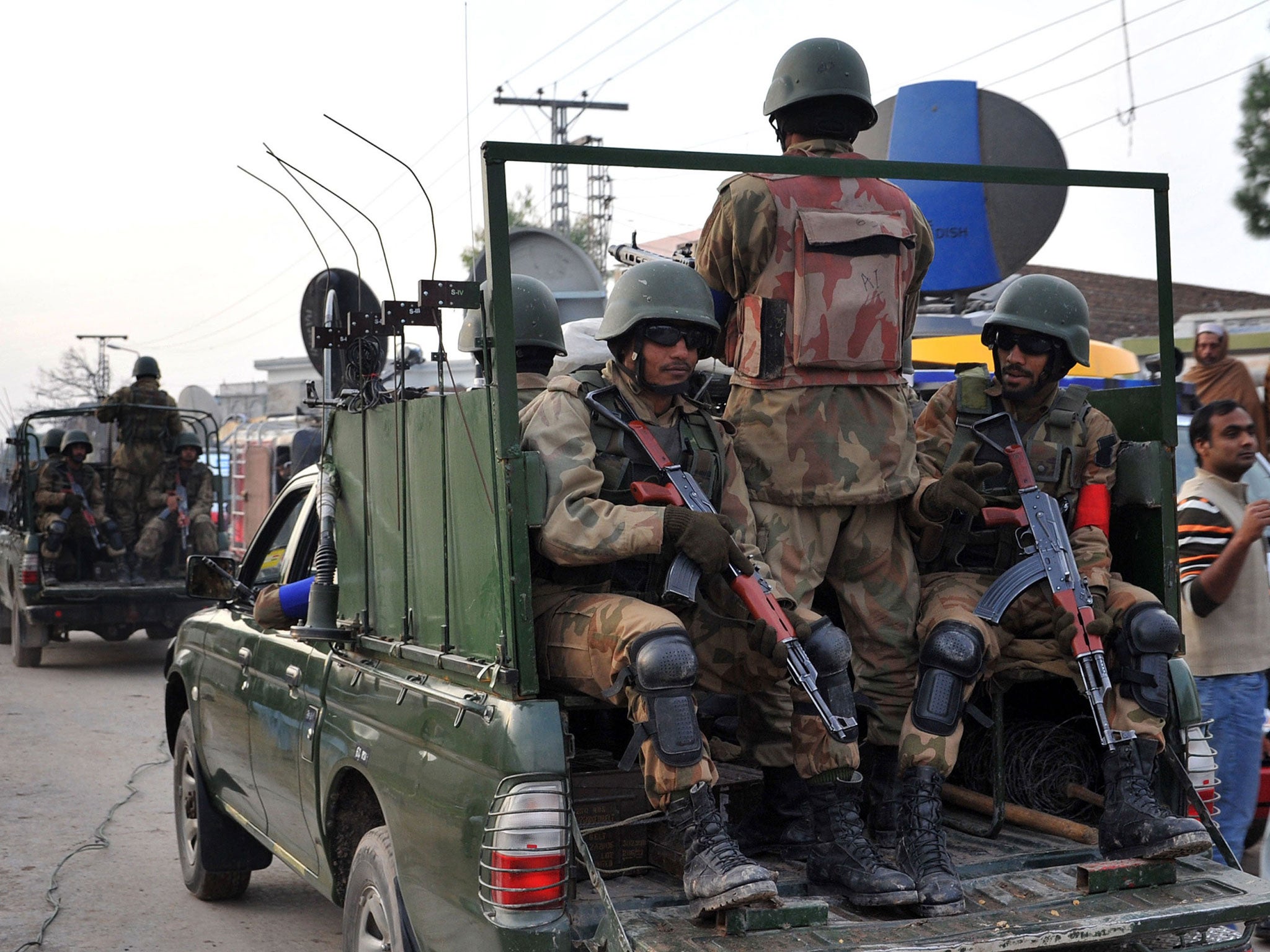 Pakistani army soldiers patrol outside the airport in Peshawar after the Pakistani Taliban claimed responsibility for suicide attack on an international airport earlier this month
