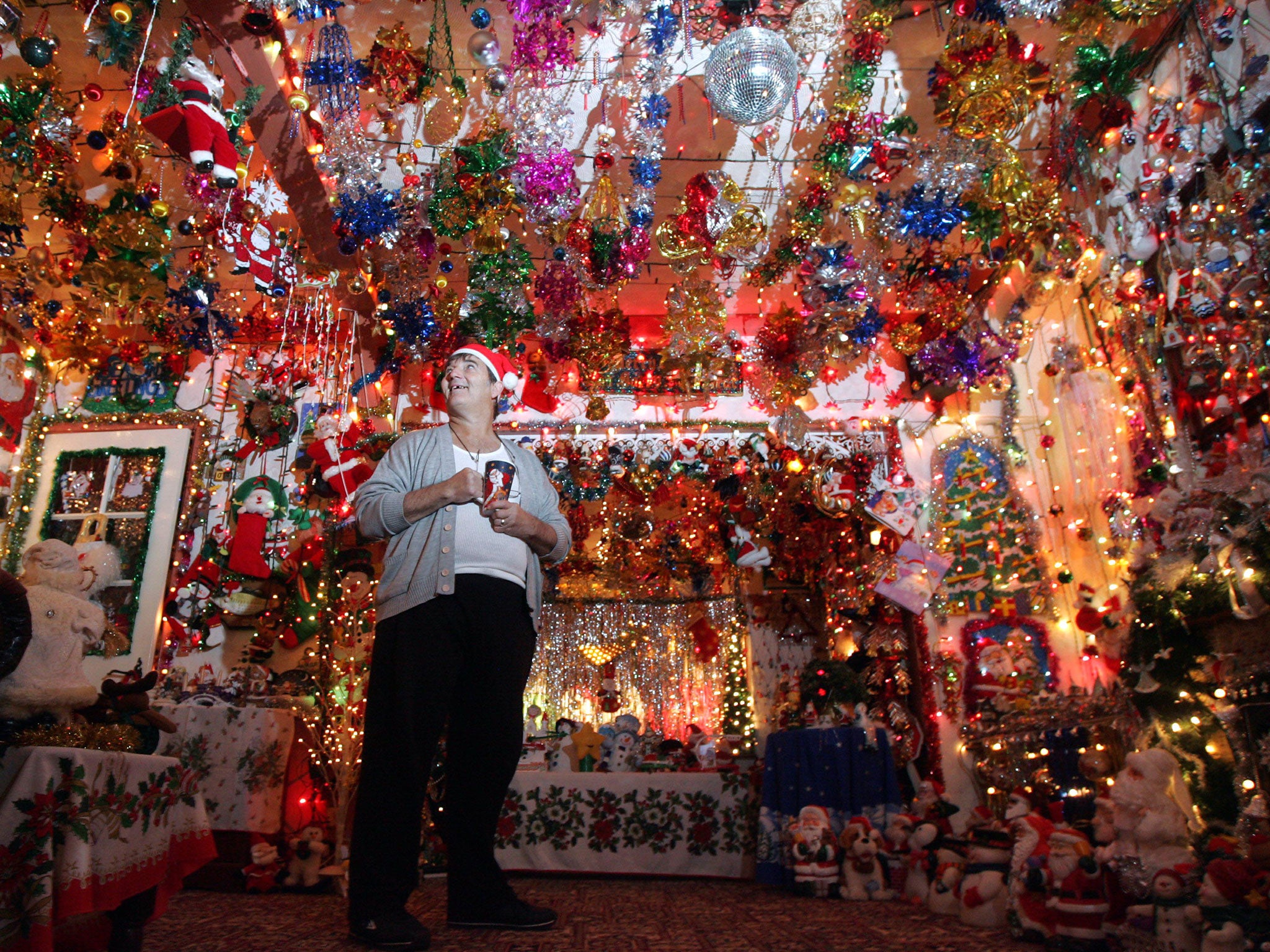 Bernard Lumsden poses inside his house, illuminated by Christmas decorations on December 16, 2005 in Bristol, England.
