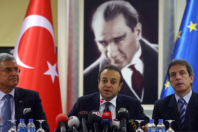 Turkish State Minister of Charges of European Union Egemen Bagis (C) speaks to the media in Ankara on November 9, 2010.