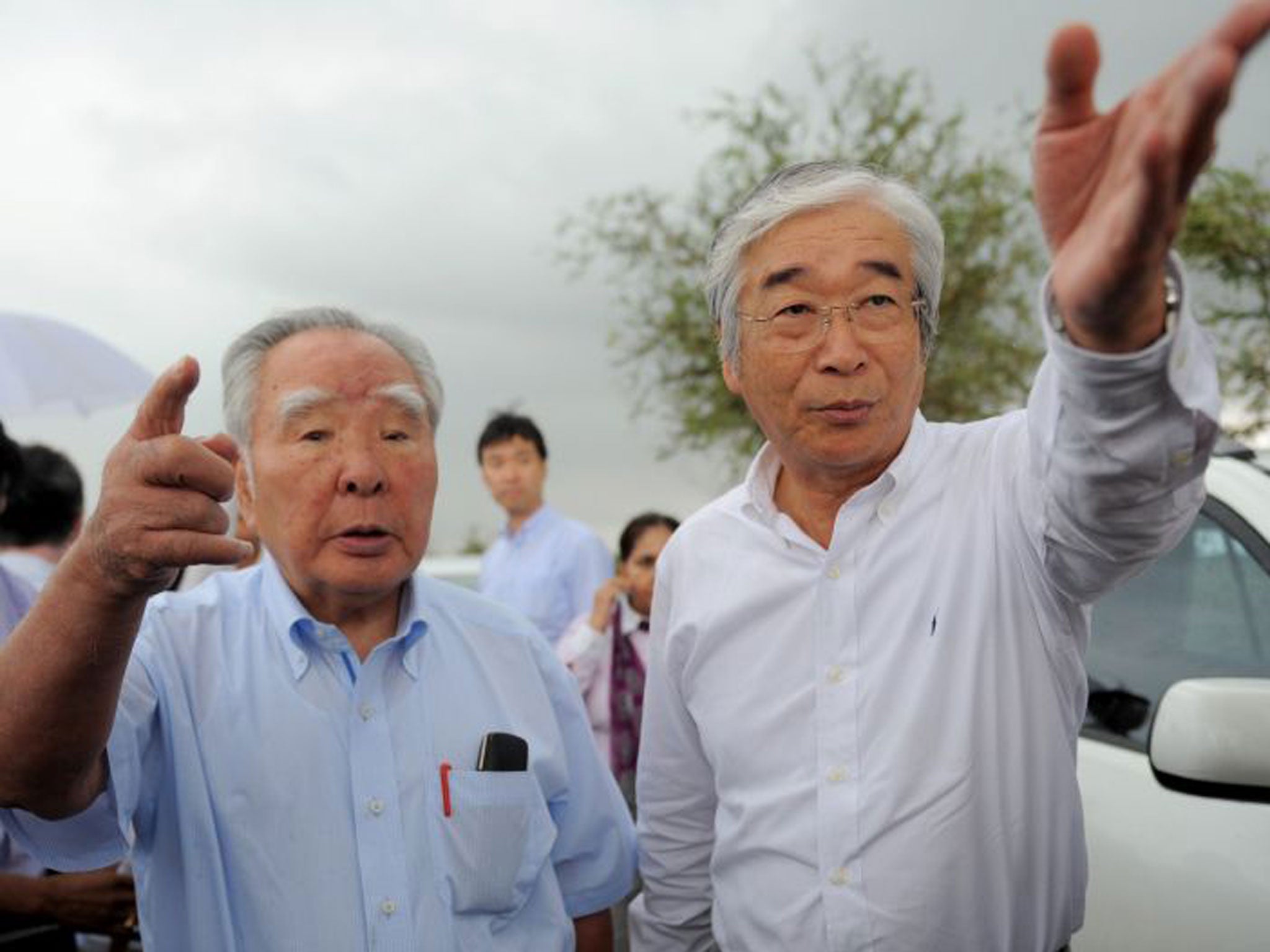 Osamu Suzuki, left, is the fourth adopted son to run the family company