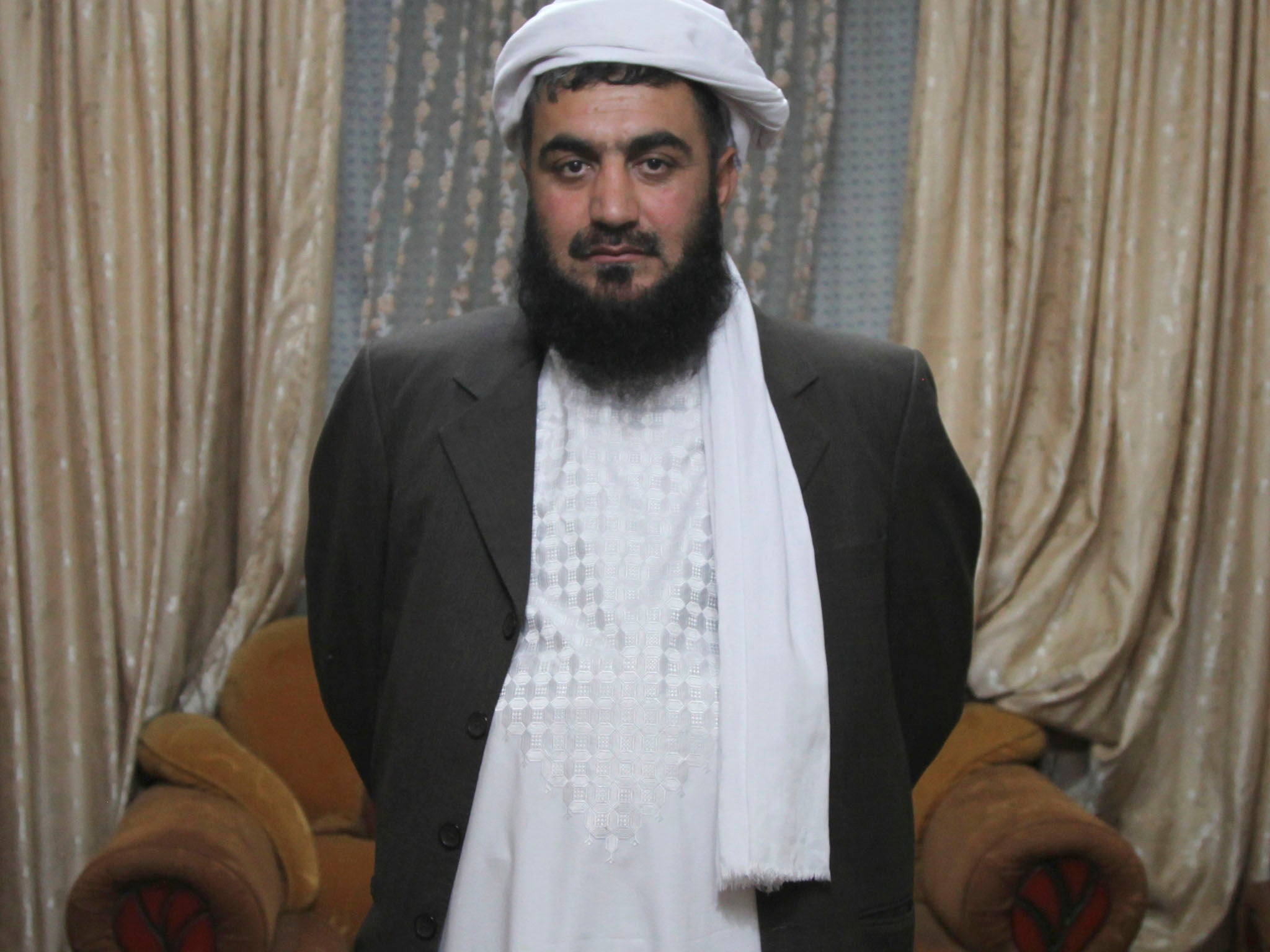 Masood Akhundzada stands in his family's Kabul home. For 250 years, his family has guarded Afghanistan's most famous shrine, containing a cloak that many believe belonged to the prophet Muhammad. Several of Akhundzada's family members have been assassinated for their role as protectors of the cloak, once claimed by the Taliban.