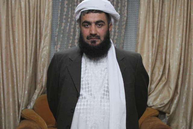 Masood Akhundzada stands in his family's Kabul home. For 250 years, his family has guarded Afghanistan's most famous shrine, containing a cloak that many believe belonged to the prophet Muhammad. Several of Akhundzada's family members have been assassinated for their role as protectors of the cloak, once claimed by the Taliban.