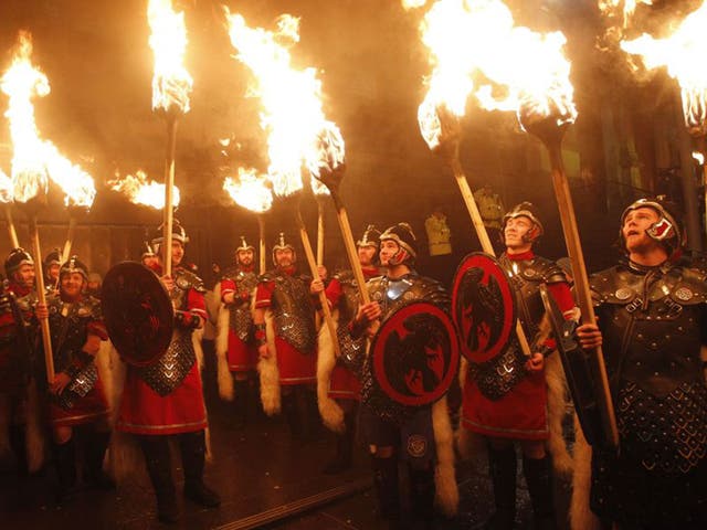 People take part in a torchlight procession through Edinburgh as part of the pre Hogmanay celebrations
