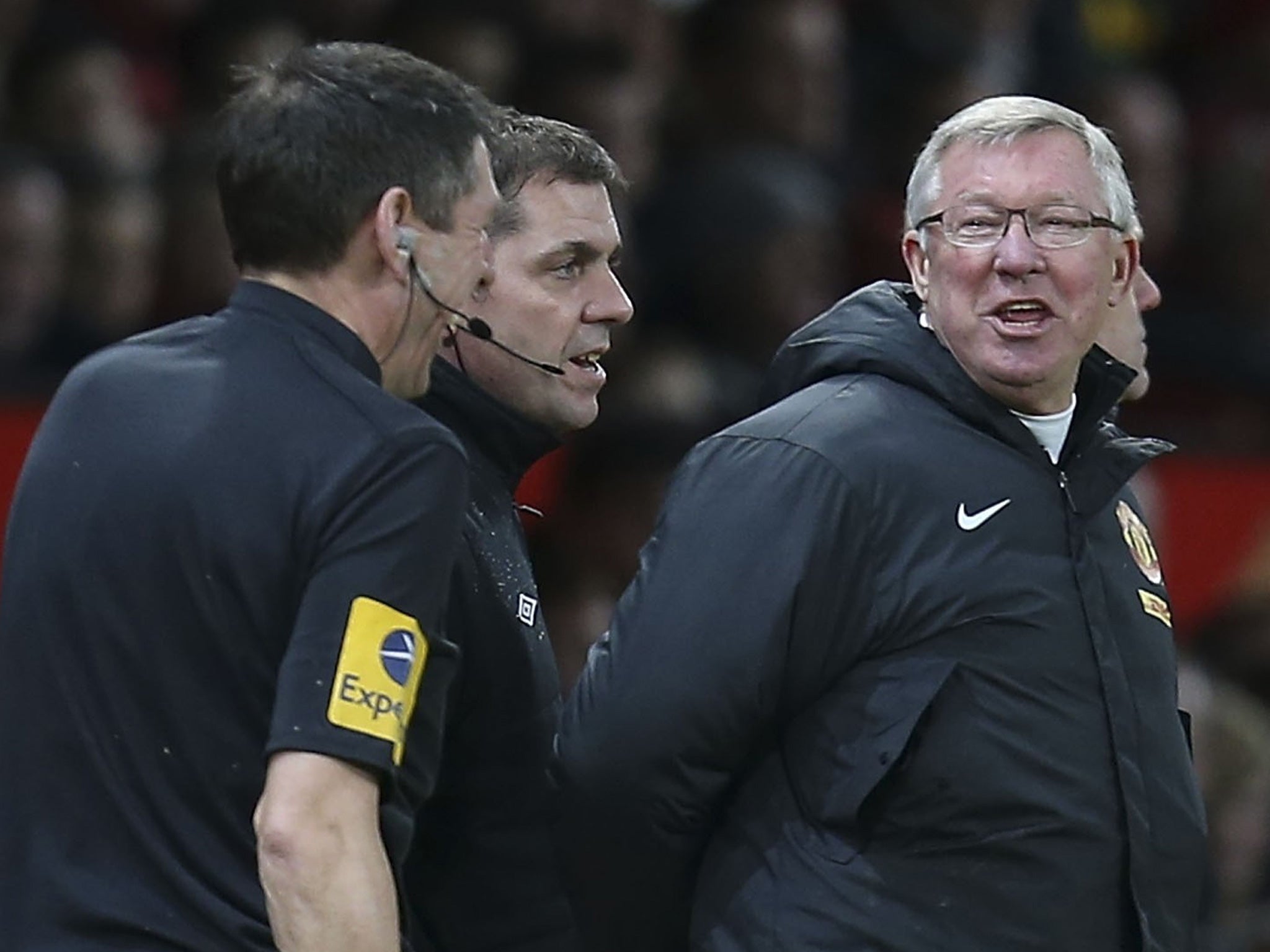 Sir Alex Ferguson shares a joke with assistant referee