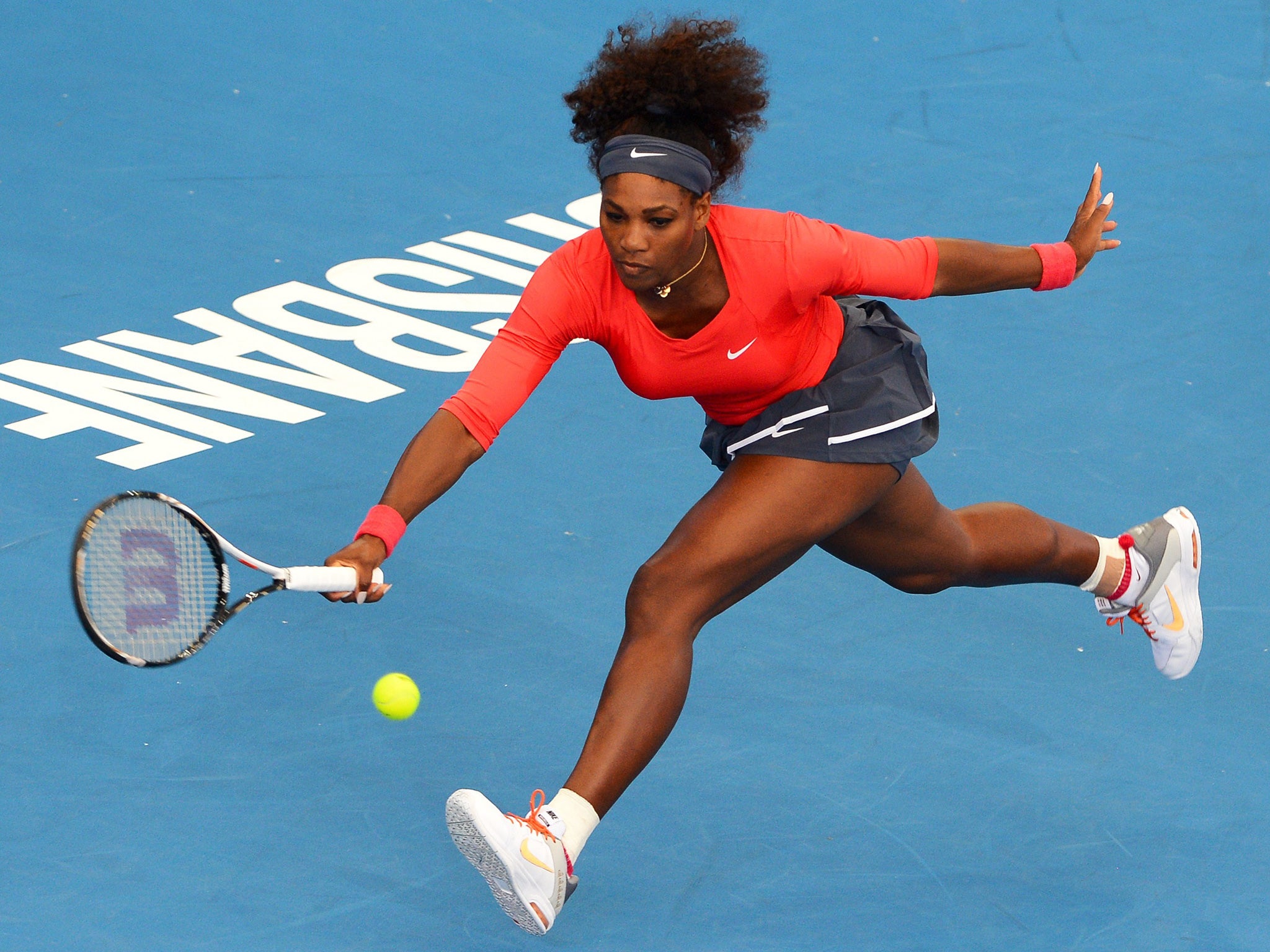 Serena Williams stretches to make a return during her first-round win in Brisbane