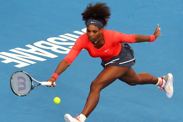 Serena Williams stretches to make a return during her first-round win in Brisbane
