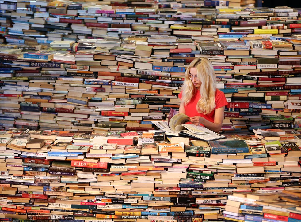 Employee Tilly Shiner looks at a book in the aMAZEme labyrinth at The Southbank Centre on July 31, 2012 in London, England.