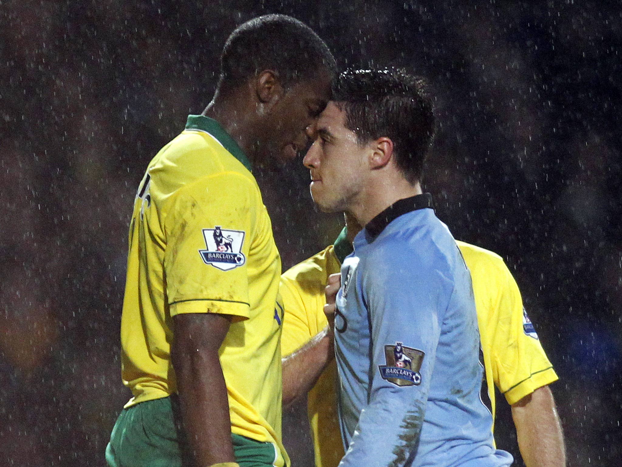 Samir Nasri confronts Norwich City's Cameroonian defender Sebastien Bassong