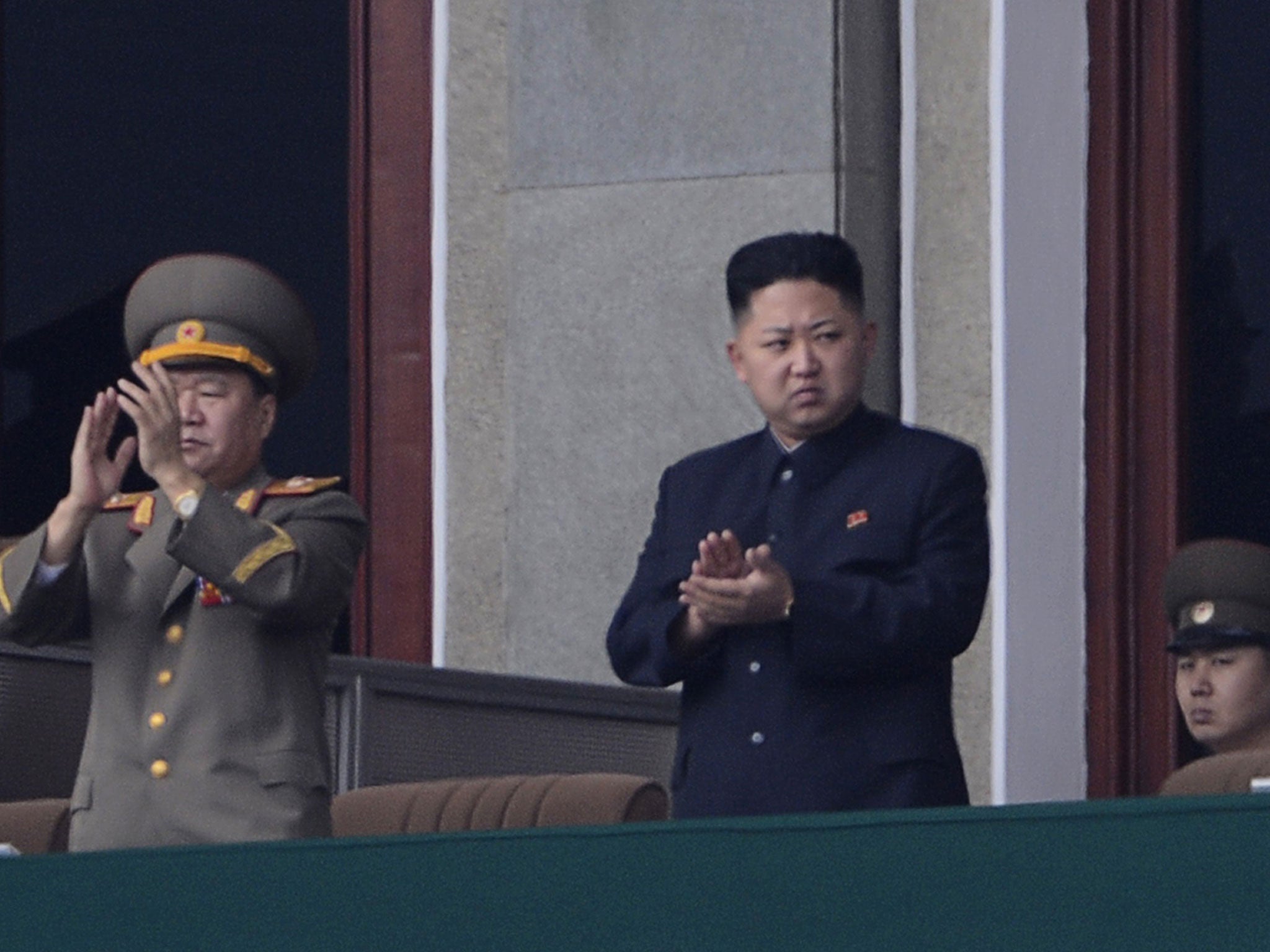 North Korean leader Kim Jong-Un (C) applauds during a official ceremony at a stadium in Pyongyang on April 14, 2012.