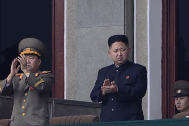 North Korean leader Kim Jong-Un (C) applauds during a official ceremony at a stadium in Pyongyang on April 14, 2012.