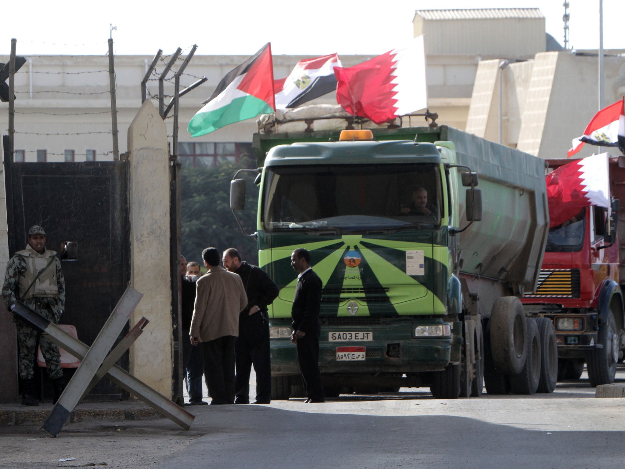 An Egyptian truck loaded with gravel prepares to enter through the Rafah border crossing, between Egypt and Gaza Strip, in the southern Gaza Strip as building material for the Qatari grant projects begin arriving.