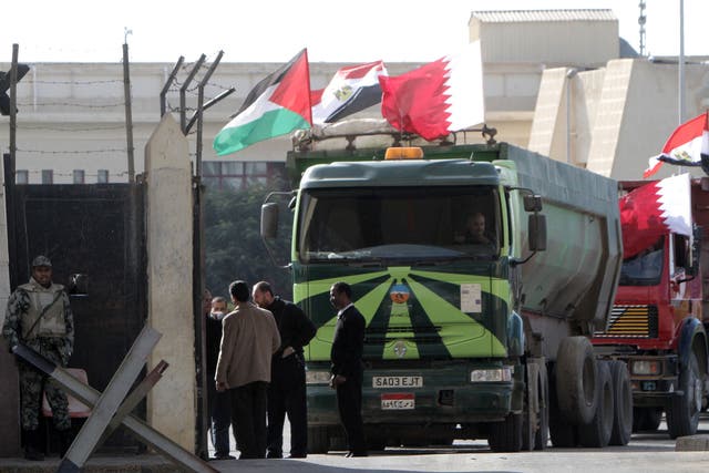 An Egyptian truck loaded with gravel prepares to enter through the Rafah border crossing, between Egypt and Gaza Strip, in the southern Gaza Strip as building material for the Qatari grant projects begin arriving. 