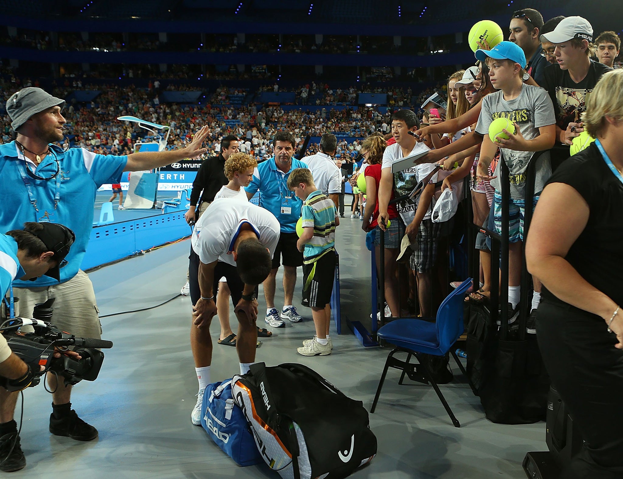 A group of young tennis enthusiasts injured Novak Djokovic as he was signing autographs at the Hopman Cup in Perth