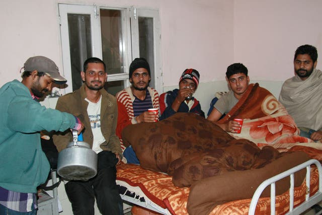 Recovering drug addicts take tea and huddle under blankets in a de-addiction center in the northern Indian city of Tarn Taran Sahib 