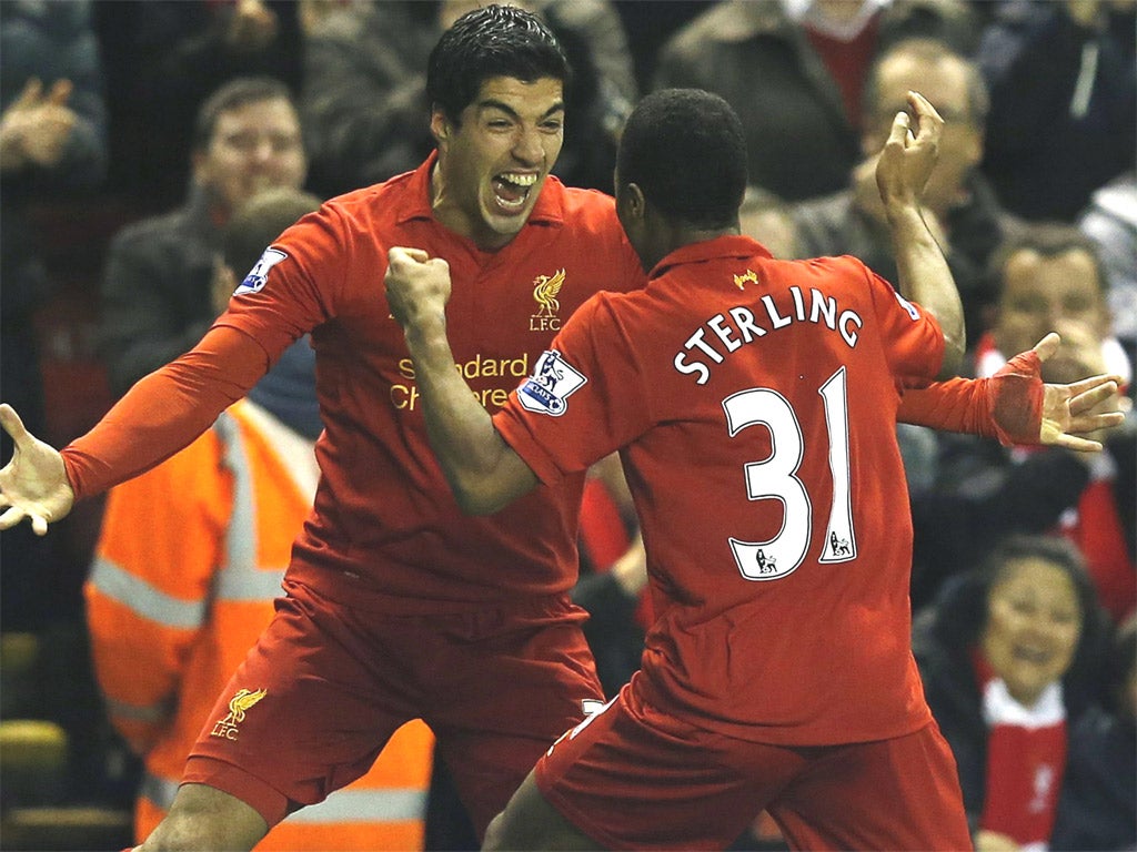 Liverpool’s Luis Suarez congratulates Raheem Sterling