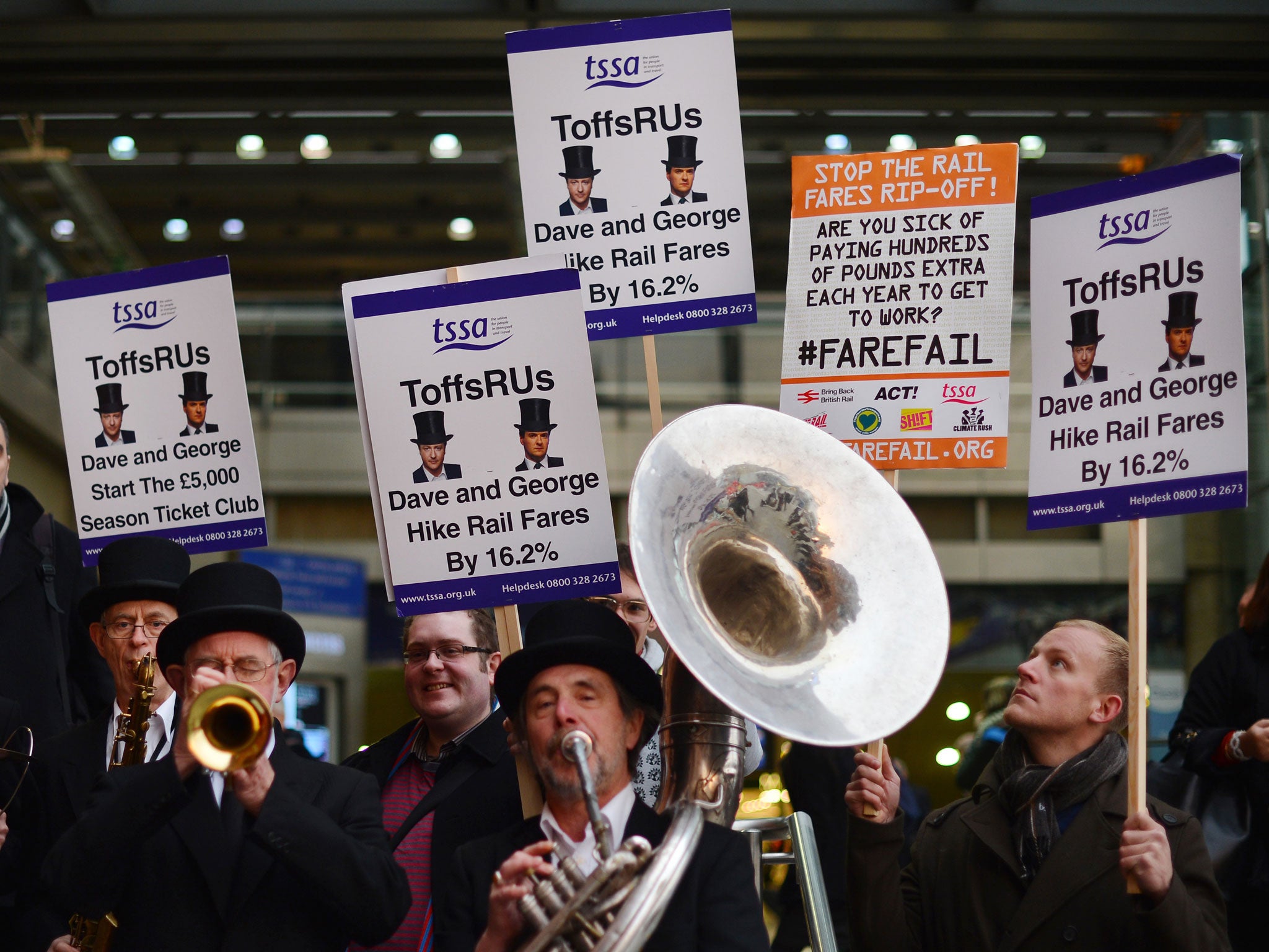 The 'ToffsRUs' jazz band play during a demonstration against a hike in rail fares at Kings Cross station in central London on January 2, 2013.