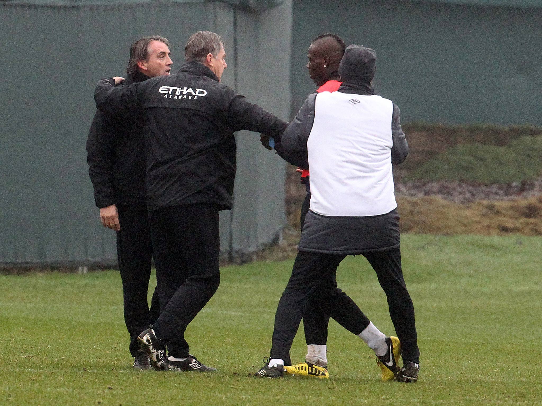 Roberto Mancini and Mario Balotelli are separated in an incident during his last Premier League spell