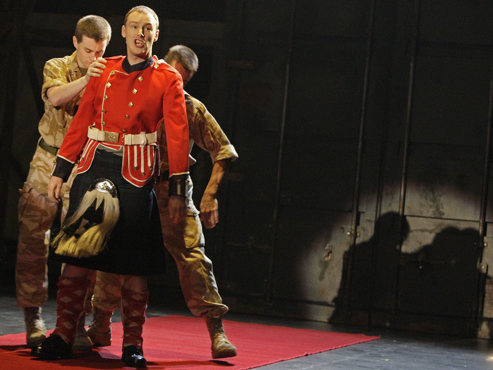 Scottish actor Paul James Corrigan (2nd-L) is changing identity during a rehearsal at the play 'Black Watch' in a Sydney theatre, 10 January 2008.