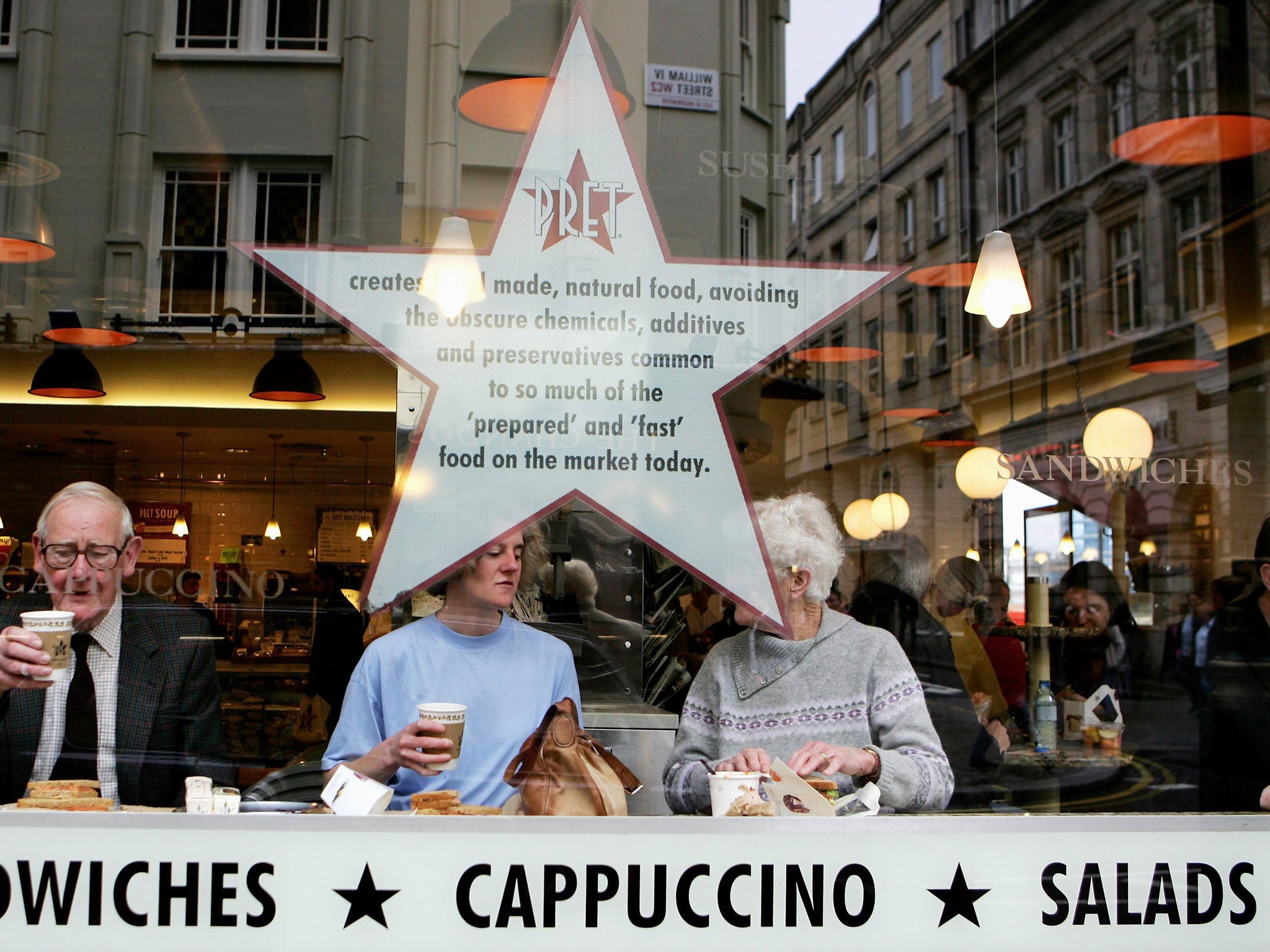People drink coffee at a Pret A Manger store in central London on April 25, 2006 in London, England.