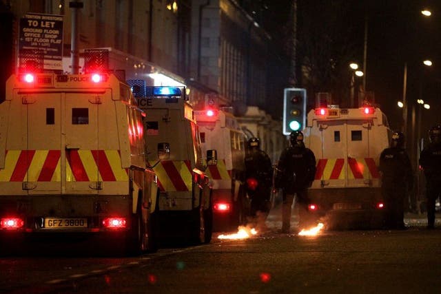 Police stand guard during last night's protests in Belfast
