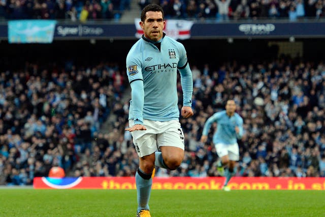 Manchester City's Argentinian striker Carlos Tevez celebrates scoring from a free kick