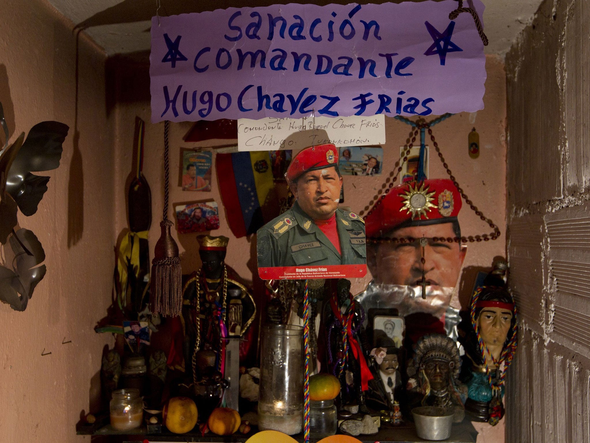 Pictures of president-elect Hugo Chavez at an altar in Caracas yesterday
