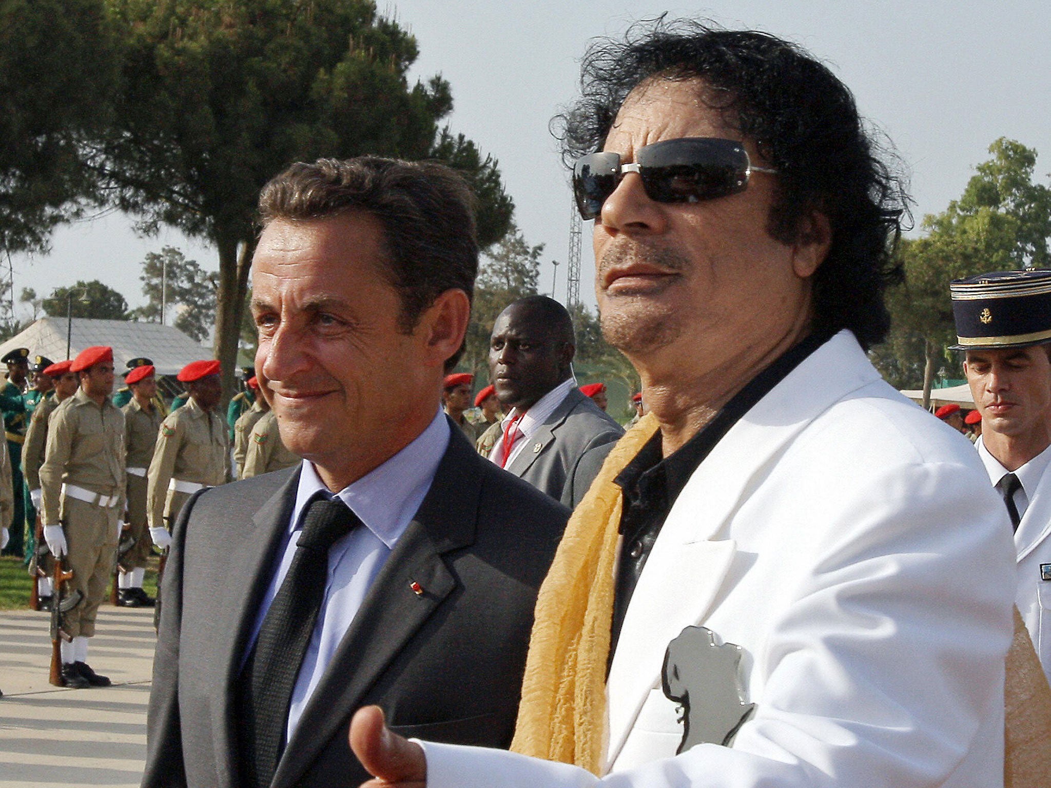 Nicolas Sarkozy is welcomed to Libya by Muammar Gaddafi in 2007