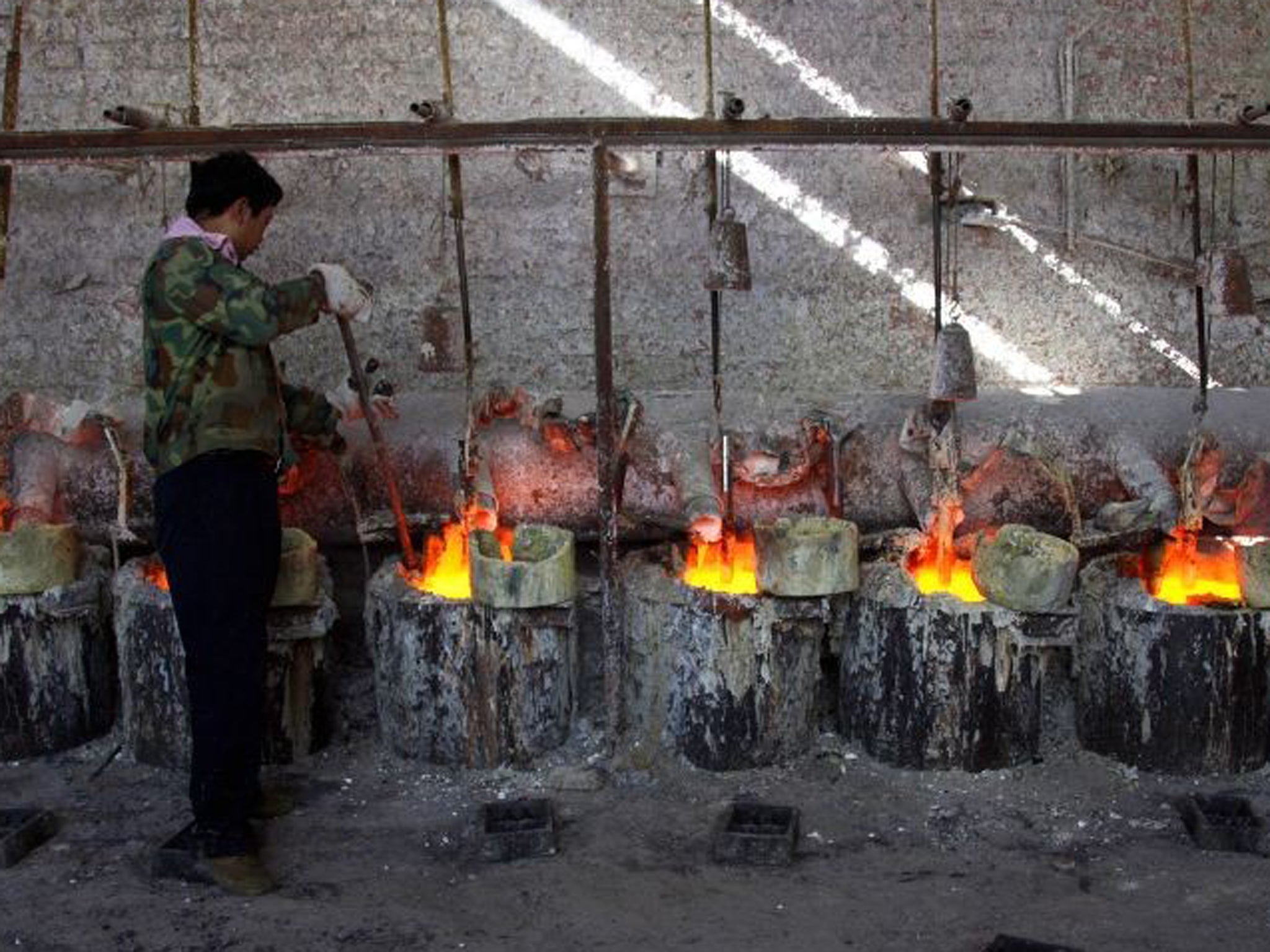 A Chinese worker smelts the rare earth metal Lanthanum