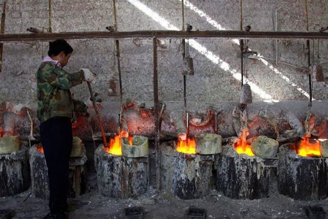 A Chinese worker smelts the rare earth metal Lanthanum