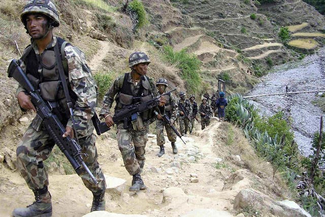 Nepalese soldiers patrol in Rolpa, about 350km west of Kathmandu, a year before the end of the Maoist conflict in 2006