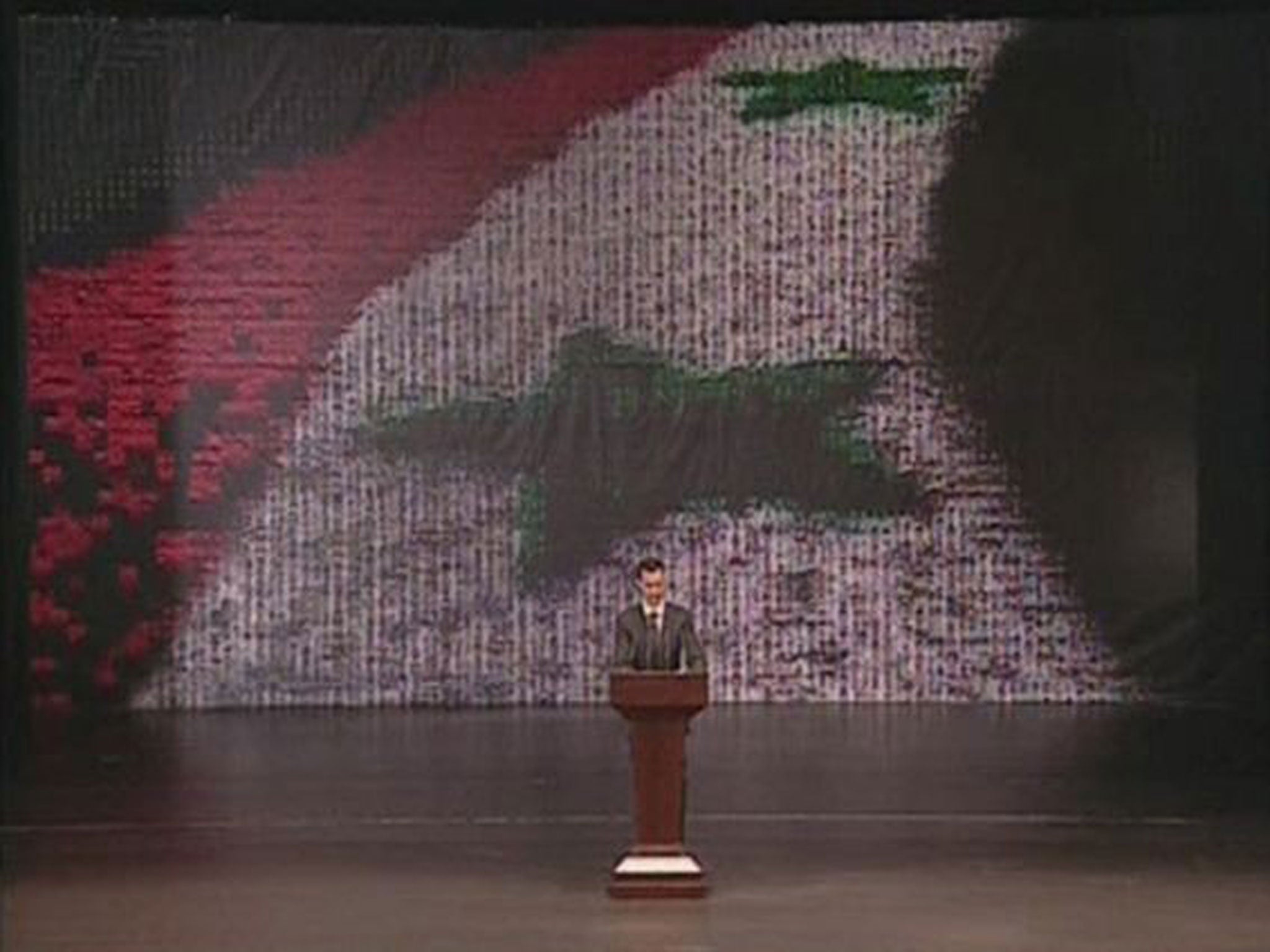 Syria's President Bashar al-Assad speaks at the Opera House in Damascus in this still image taken from video