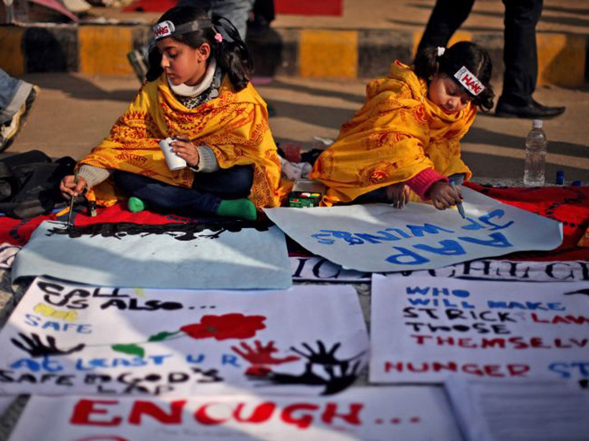 Children paint messages during a gathering in Delhi to mourn rape victim Jyoti Singh Pandey