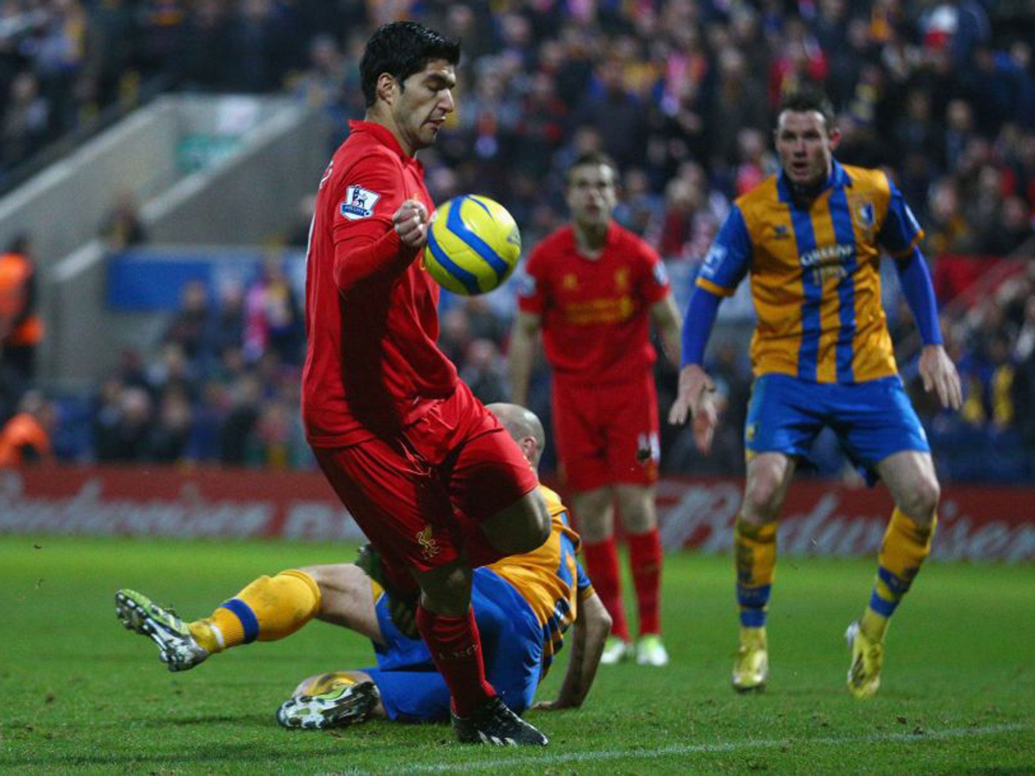 Luis Suarez clearly handles the ball before scoring Liverpool’s second goal against Mansfield in the FA Cup yesterday