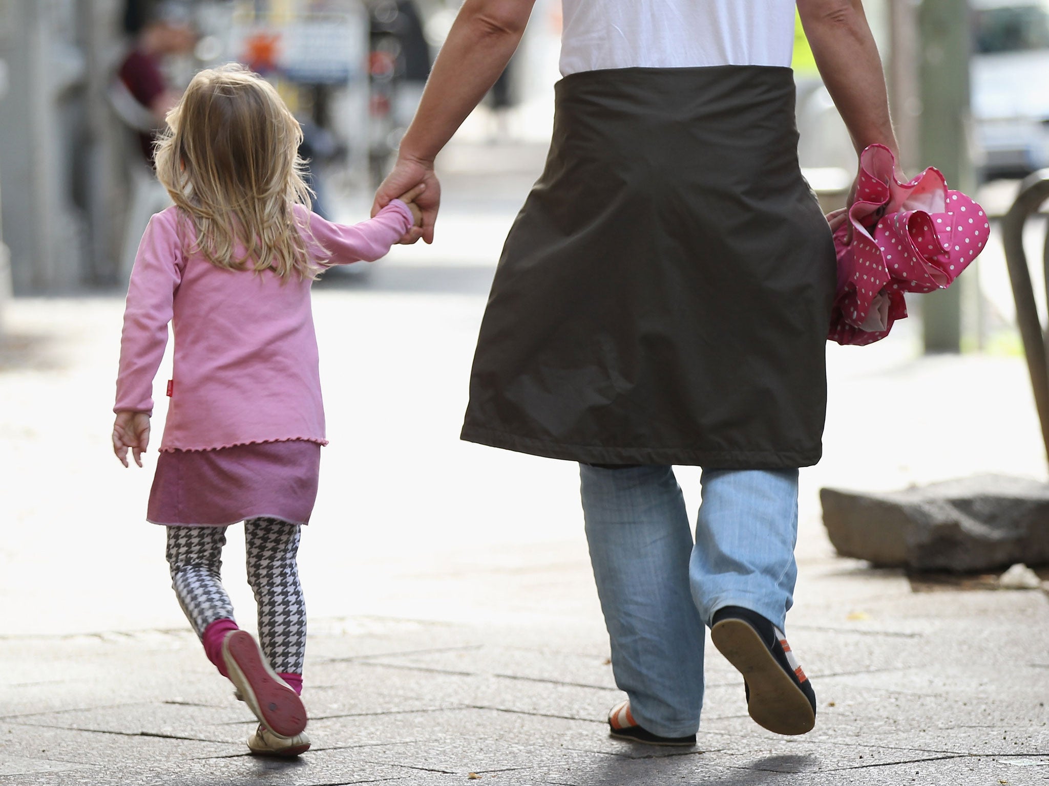 A father and daughter walk in the city center on July 17, 2012 in Berlin, Germany.