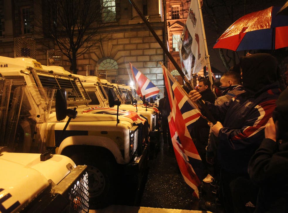 Loyalist protesters confront police at Belfast City Hall last night 