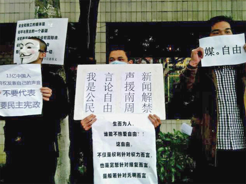 Demonstrators call for press freedom in support of journalists from the Southern Weekend newspaper outside the company's office building in Guangzhou, southern China