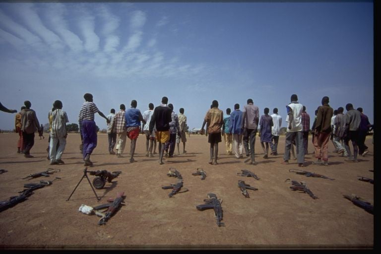 Boys in southern Sudan walk away from the weapons they once carried