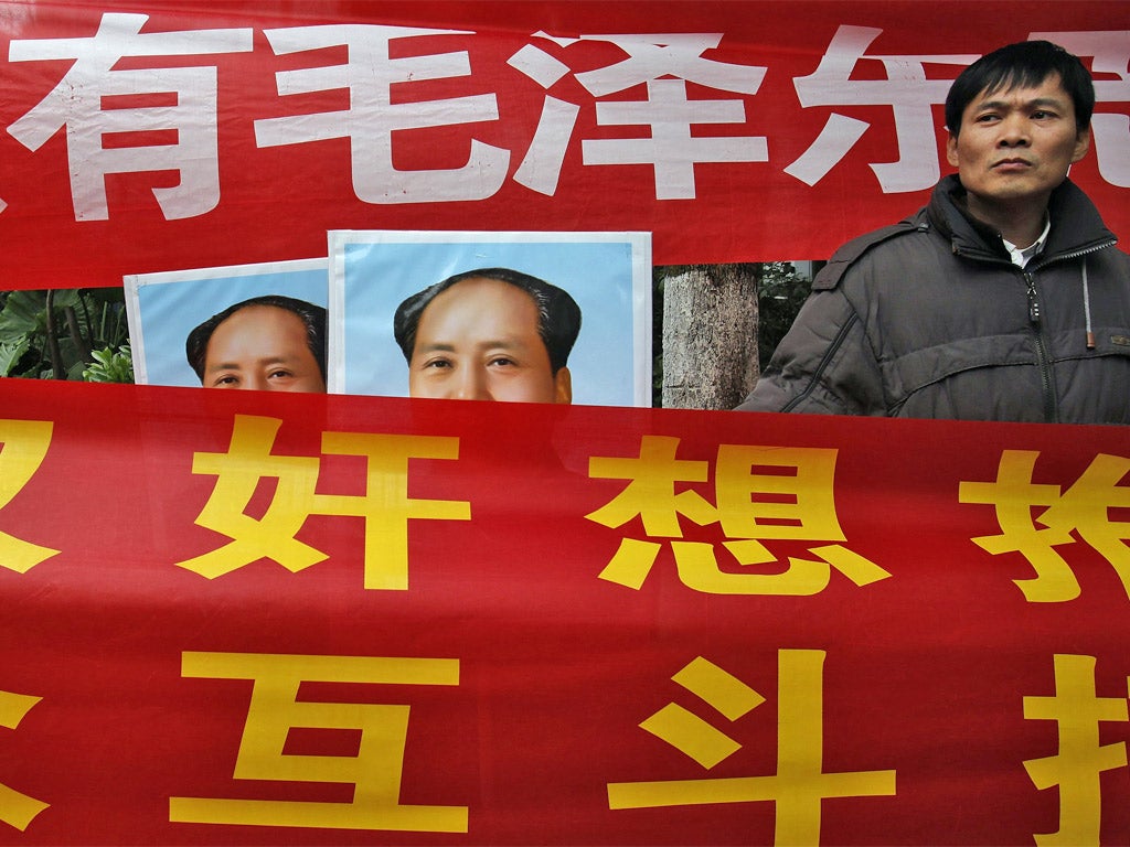 Leftists displaying banners and portraits of the late Chinese leader