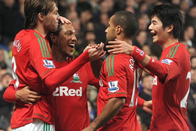 The Swansea players celebrate Michu’s opener
