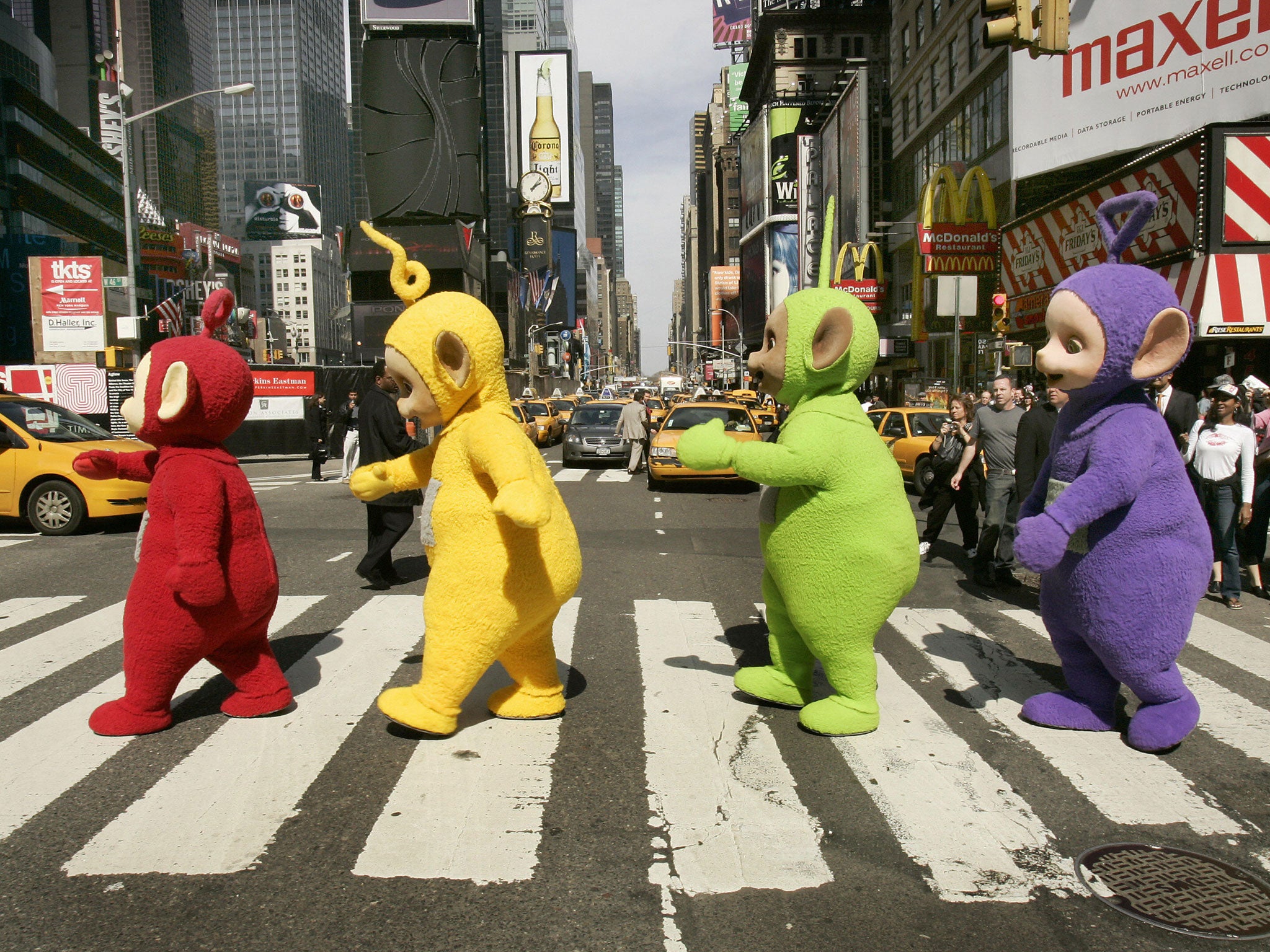 The world famous Teletubbies (L-R) Po, Laa-Laa, Dipsy and Tinky-Winky cross 7th Avenue in Times Square in New York 27 March 2007 as they arrive on American soil in person for the first time ever.