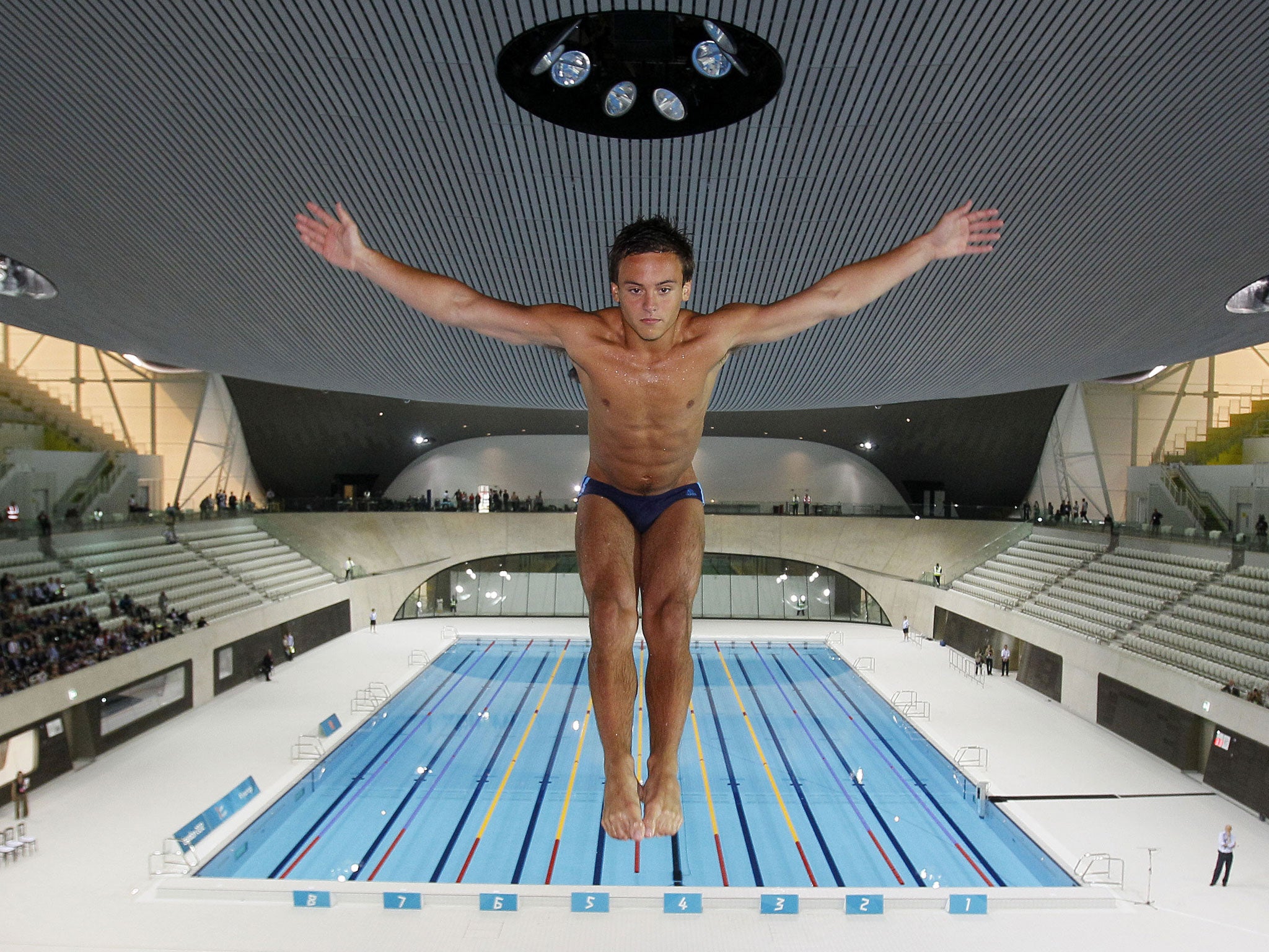 British Olympic diver Tom Daley dives into a new aquatic centre pool during the one year to go ceremony dedicated to the 2012 London Olympics, in London, on July 27, 2011.